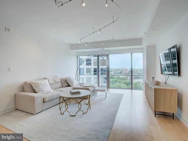 a living room with furniture and a floor to ceiling window