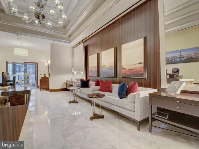 a dining room with furniture and large windows