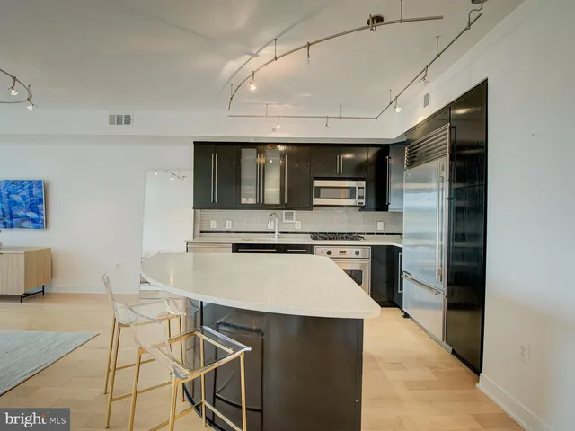 a kitchen with stainless steel appliances a stove microwave and sink