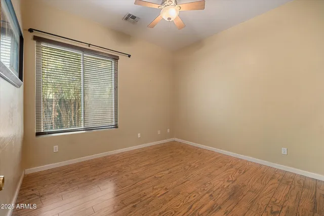 a view of an empty room and wooden floor