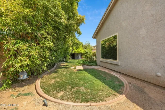 a view of hallway with window and wooden floor