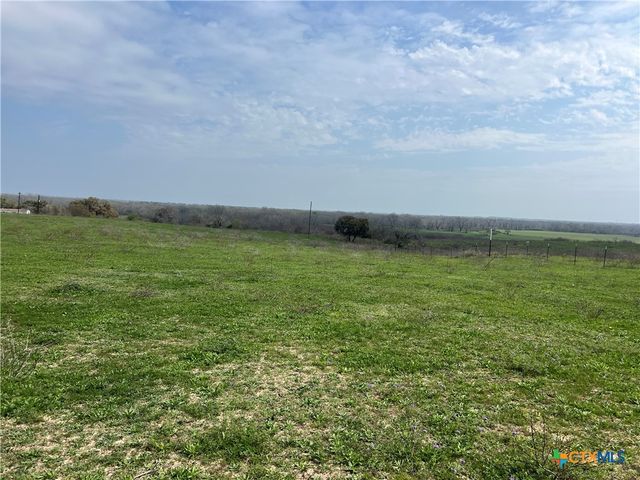 a view of a field with an ocean