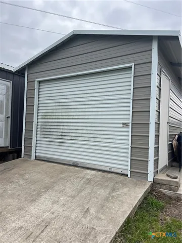 a view of a house with white door and garage
