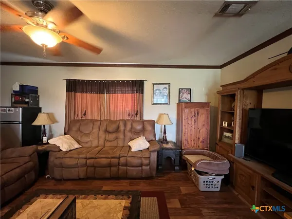 a kitchen with granite countertop a stove a sink and a microwave