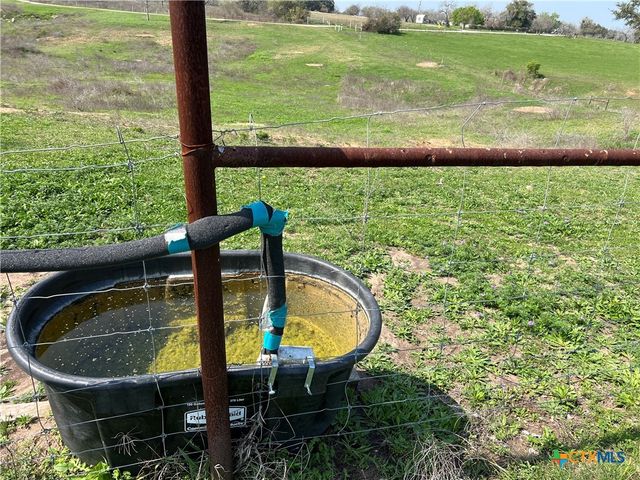 a view of a swimming pool with a lawn chairs and a lake view