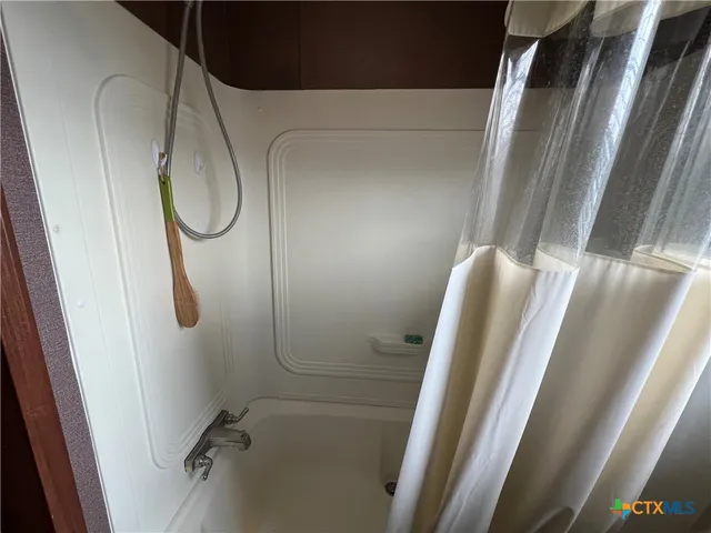 a bathroom with a shower and a toilet