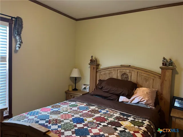 a bedroom with a bed and a chair
