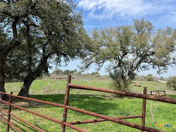 a view of a yard with iron fence