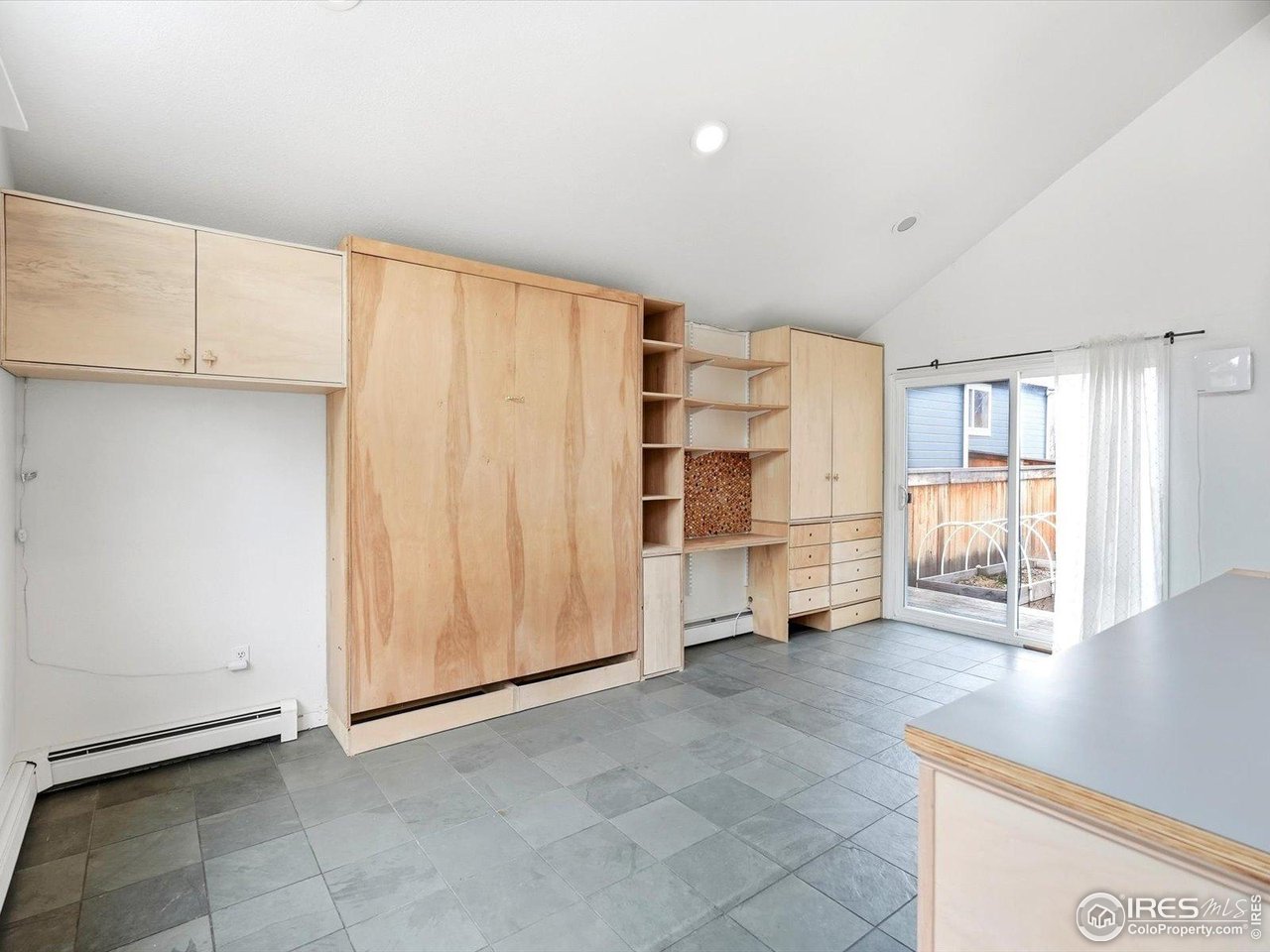 4855 Edison Avenue, Unit A Boulder, CO 80301 - Photo 10 of 44 Living space with custom built wall unit and Murphy bed.