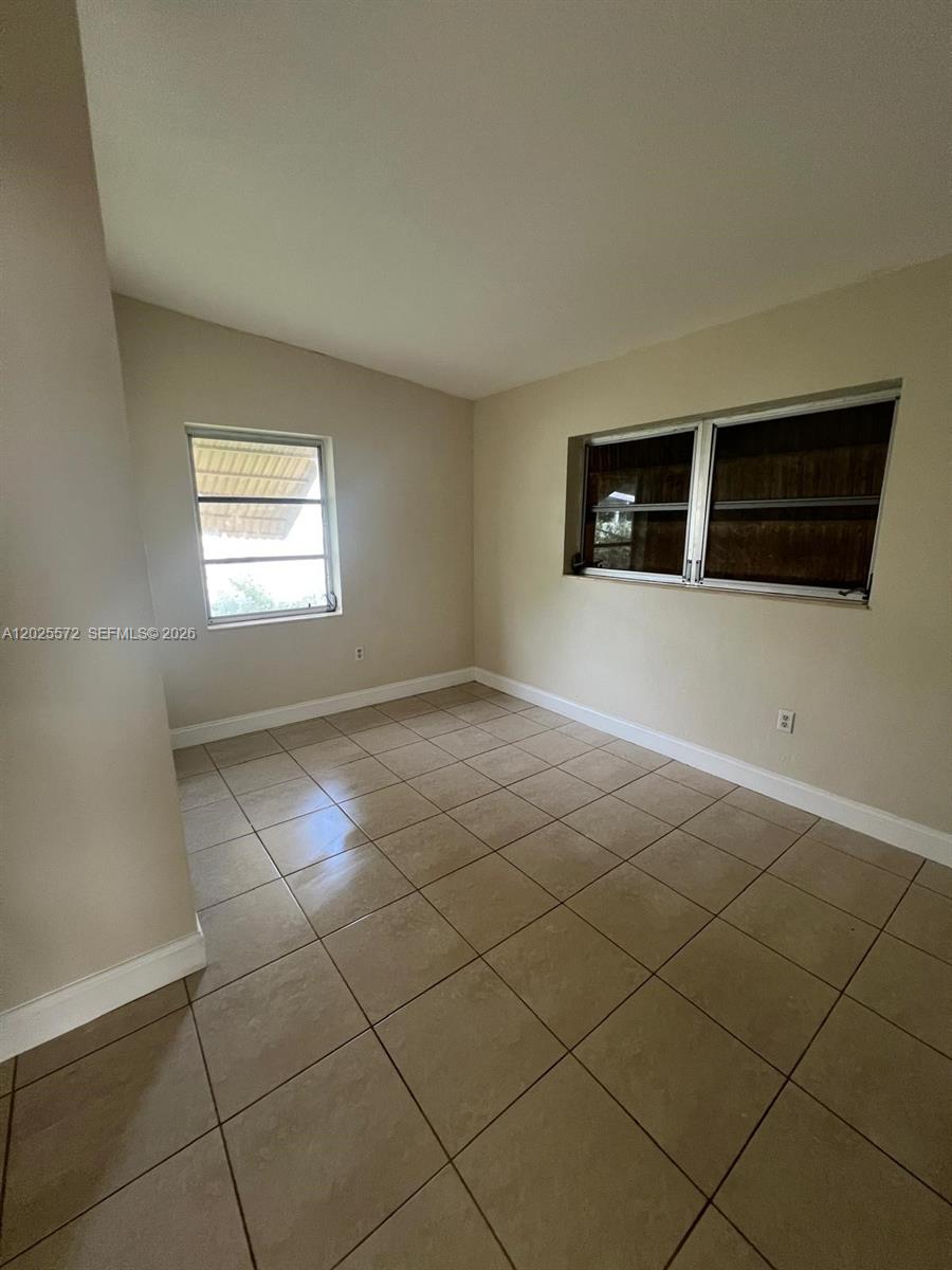 14475 Southwest 288th Street Homestead, FL 33033 - Photo 19 of 26 a view of an empty room with a window