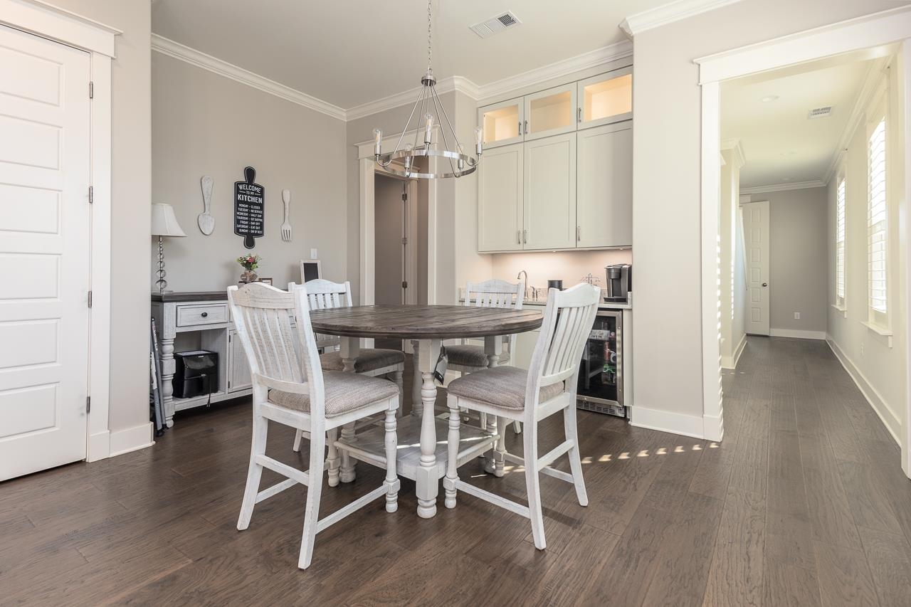 458 South Shea Road Collierville, TN 38017 - Photo 17 of 27 Dining area featuring dark wood-type flooring, wine cooler, and crown molding