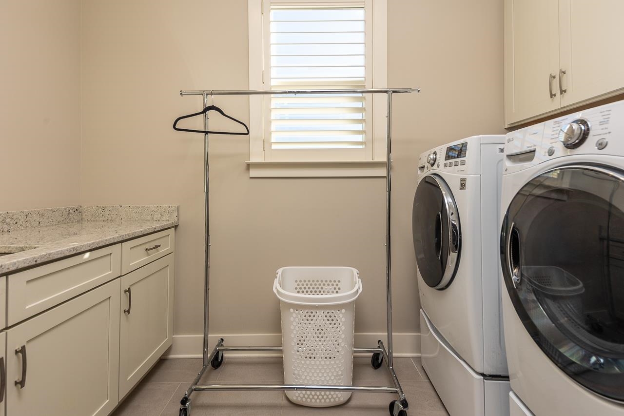 458 South Shea Road Collierville, TN 38017 - Photo 23 of 27 Laundry area featuring cabinets, tile patterned floors, and washing machine and clothes dryer