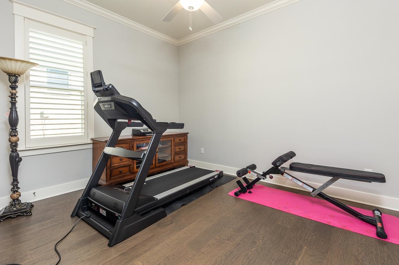 458 South Shea Road Collierville, TN 38017 - Photo 25 of 27 Exercise room featuring ceiling fan, ornamental molding, and dark hardwood / wood-style flooring
