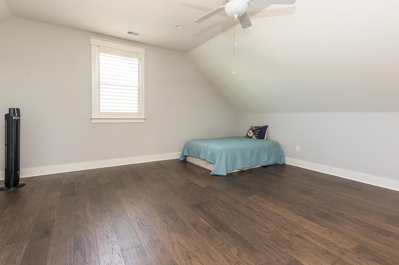 458 South Shea Road Collierville, TN 38017 - Photo 26 of 27 Unfurnished bedroom featuring dark hardwood / wood-style flooring, lofted ceiling, and ceiling fan