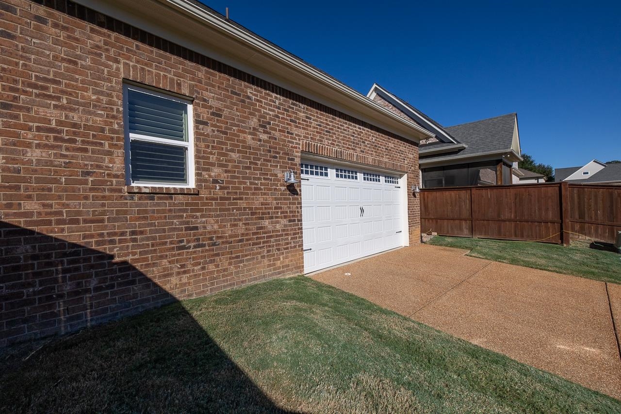 458 South Shea Road Collierville, TN 38017 - Photo 4 of 27 View of home's exterior featuring a lawn and a garage