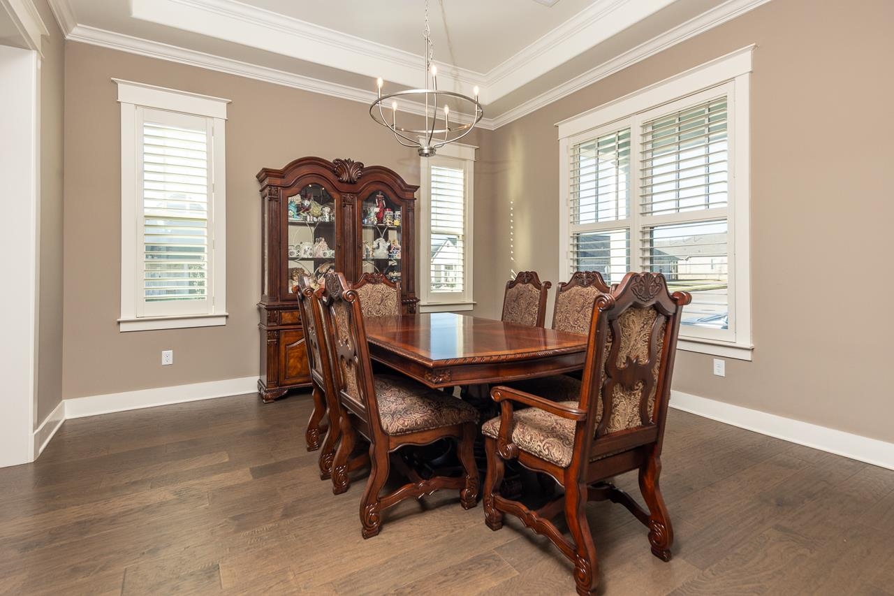 458 South Shea Road Collierville, TN 38017 - Photo 6 of 27 Dining room with ornamental molding, an inviting chandelier, and dark hardwood / wood-style flooring