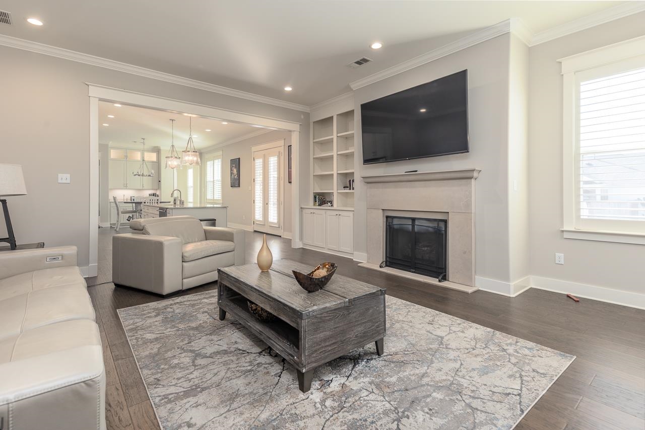 458 South Shea Road Collierville, TN 38017 - Photo 10 of 27 Living room featuring dark wood-type flooring, crown molding, sink, and a chandelier