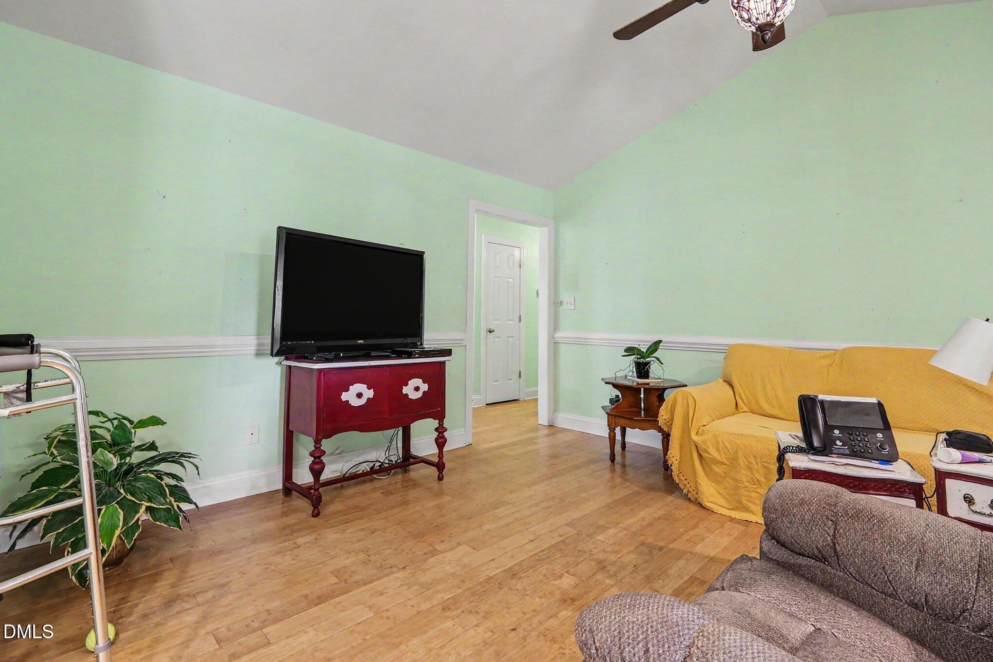 1750 Tom Oakley Road Timberlake, NC 27583 - Photo 7 of 31 a living room with furniture and a flat screen tv
