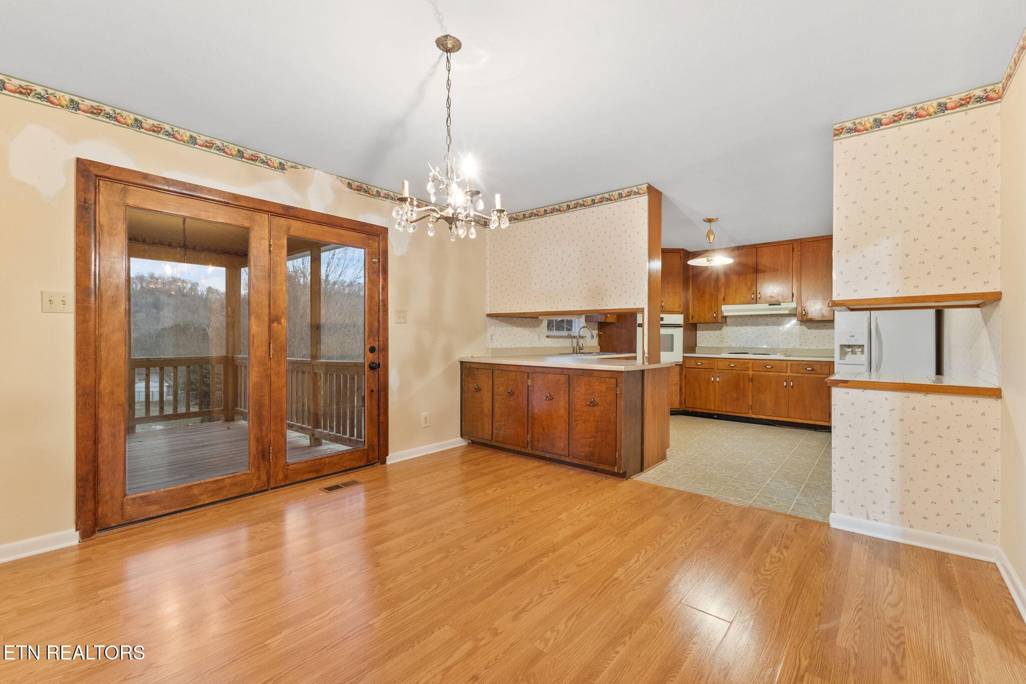 101 Albright Road Oak Ridge, TN 37830 - Photo 12 of 37 a view of a kitchen with kitchen island a sink wooden floor and a refrigerator