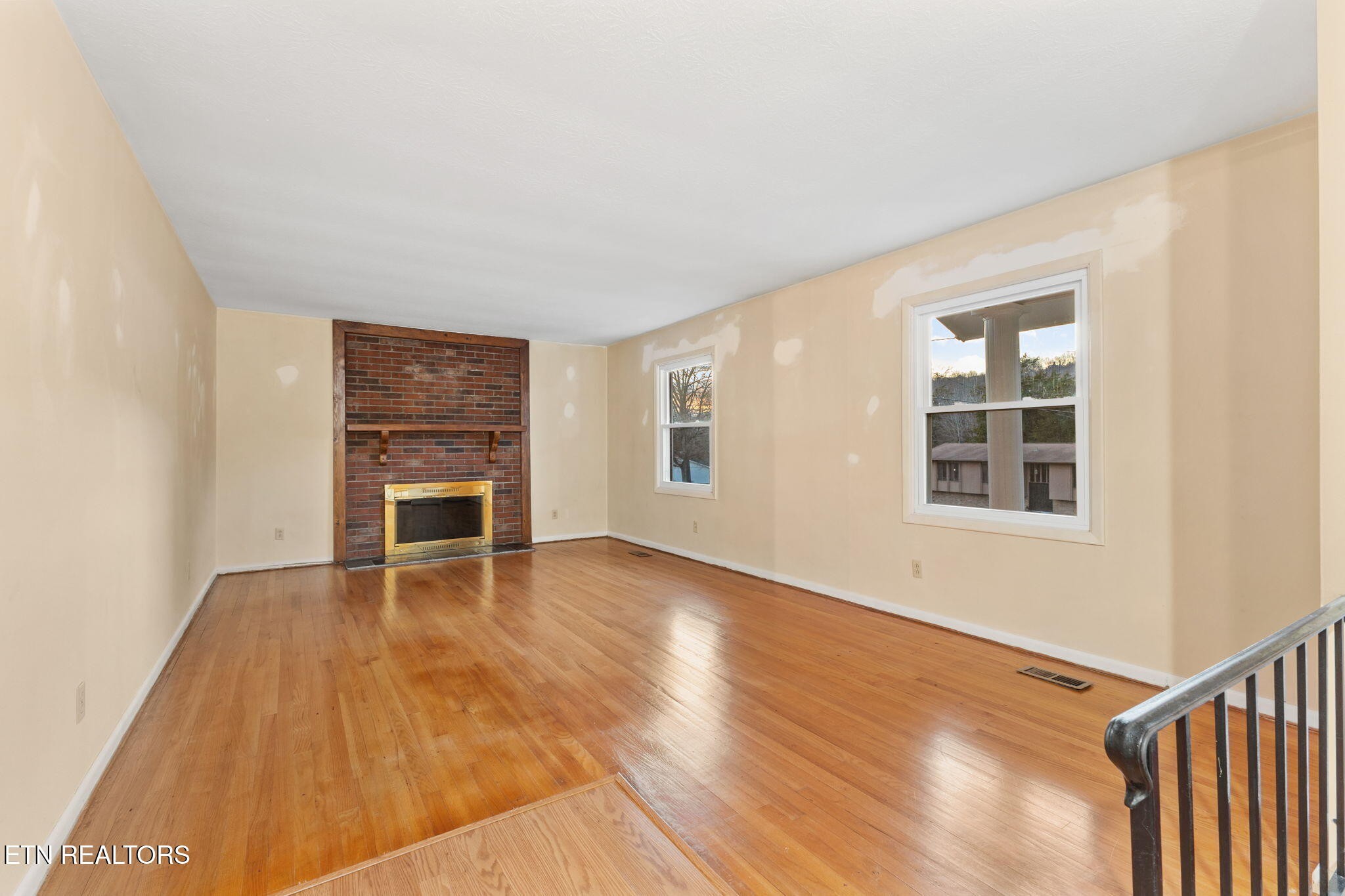 101 Albright Road Oak Ridge, TN 37830 - Photo 8 of 37 a view of an empty room with wooden floor and a window