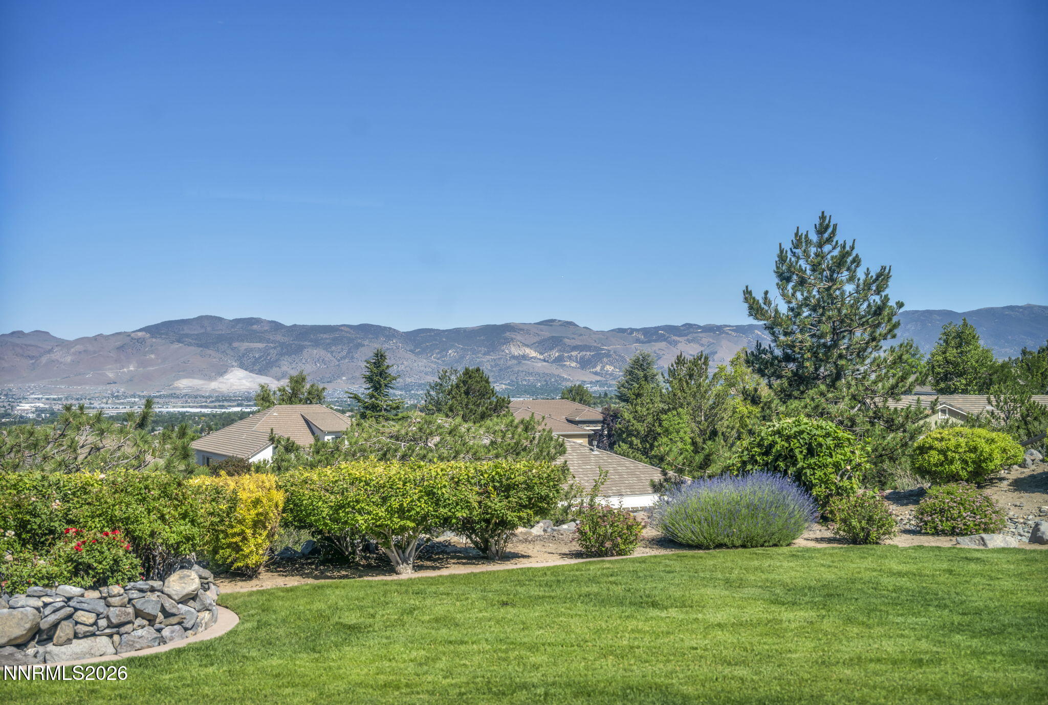 574 Echo Ridge Court Reno, NV 89511 - Photo 3 of 58 a view of a lush green field with a view of mountains in the background