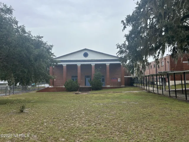 a view of a porch with a table and chairs