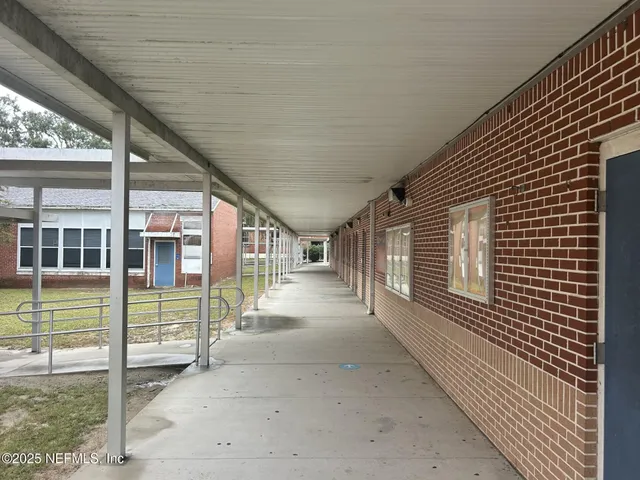 a view of a house with a backyard and porch