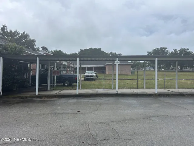a view of a green field with a view of a house