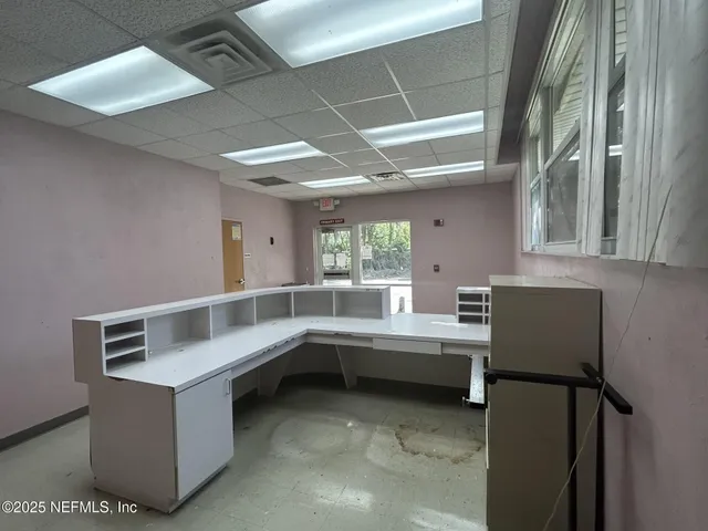 a view of an empty room with a bench