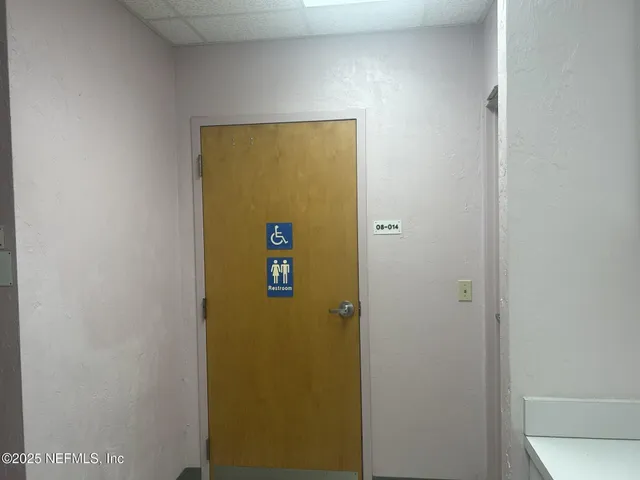 a view of a green field with wooden fence