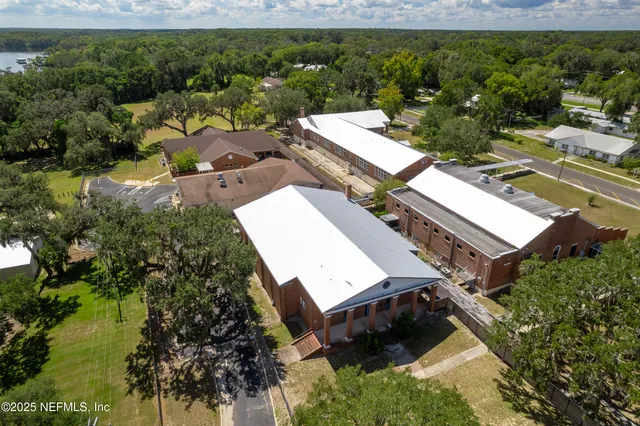 an aerial view of a house with a lake view