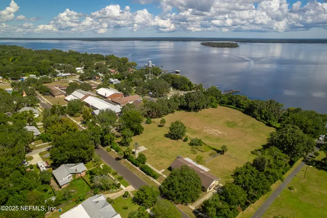 an aerial view of ocean with residential house with outdoor space
