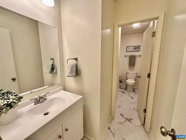 a bathroom with a sink and mirror with toilet