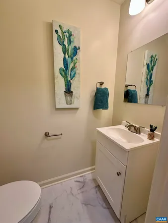 a bathroom with a sink mirror vanity and toilet