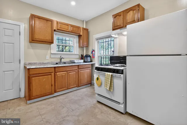 a kitchen with a sink a refrigerator and window