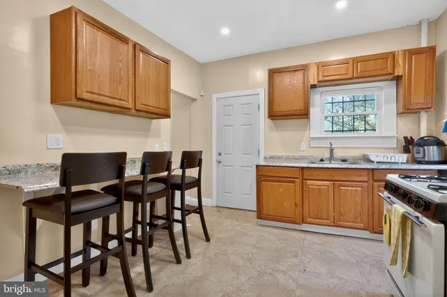 a kitchen with stainless steel appliances granite countertop a stove a sink dishwasher and a refrigerator