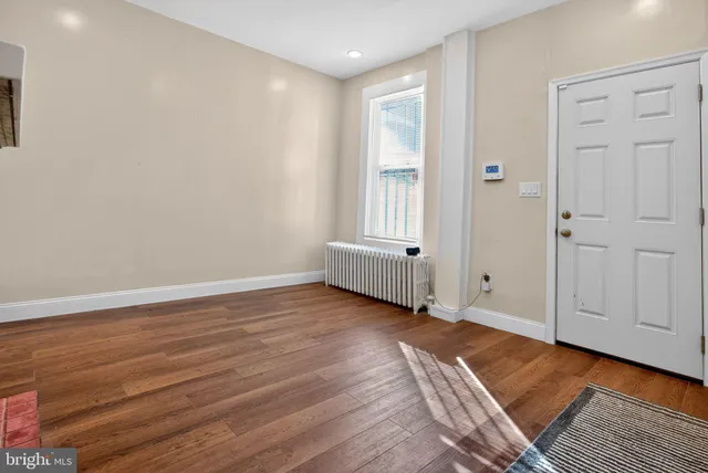 a view of a room with wooden floor and closet
