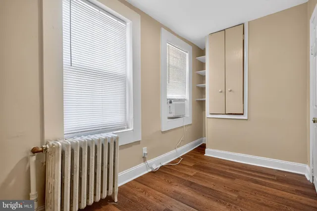 a view of a room with wooden floor and windows