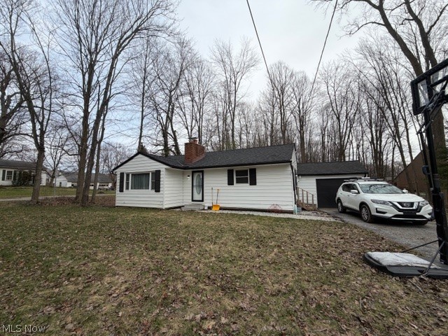 35180 Solon Road Solon, OH 44139 - Photo 2 of 33 Ranch-style home featuring a chimney, a front lawn, and a garage