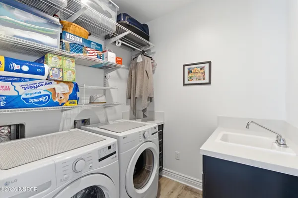 a bedroom with a large bed a rug and chair