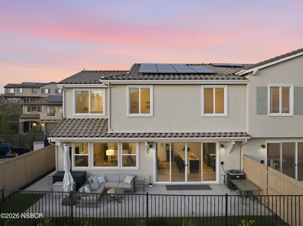 an aerial view of a house with a yard