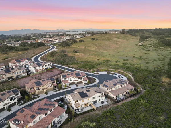 a living room with fireplace furniture and a large window