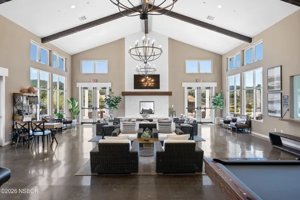 a view of a patio with table and chairs and floor to ceiling window
