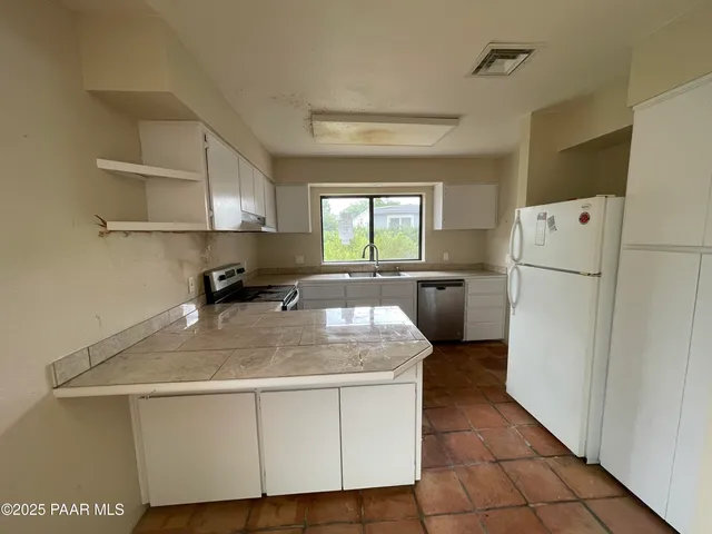 a kitchen with a refrigerator a sink and a stove