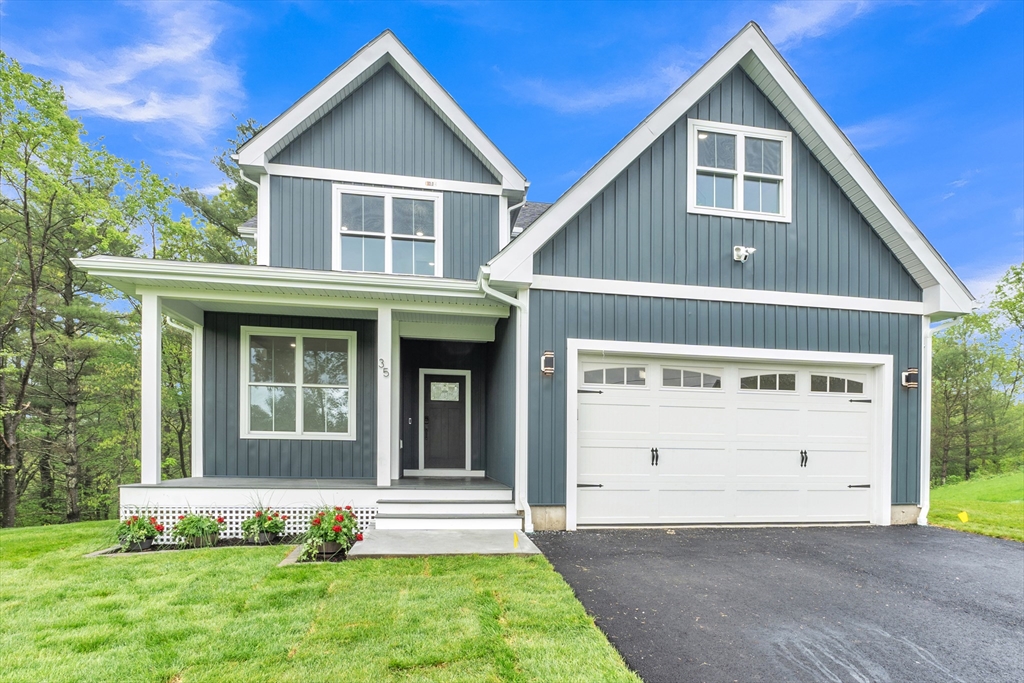 35 Blood Road Charlton, MA 01507 - Photo 1 of 38 a front view of a house with a yard and garage