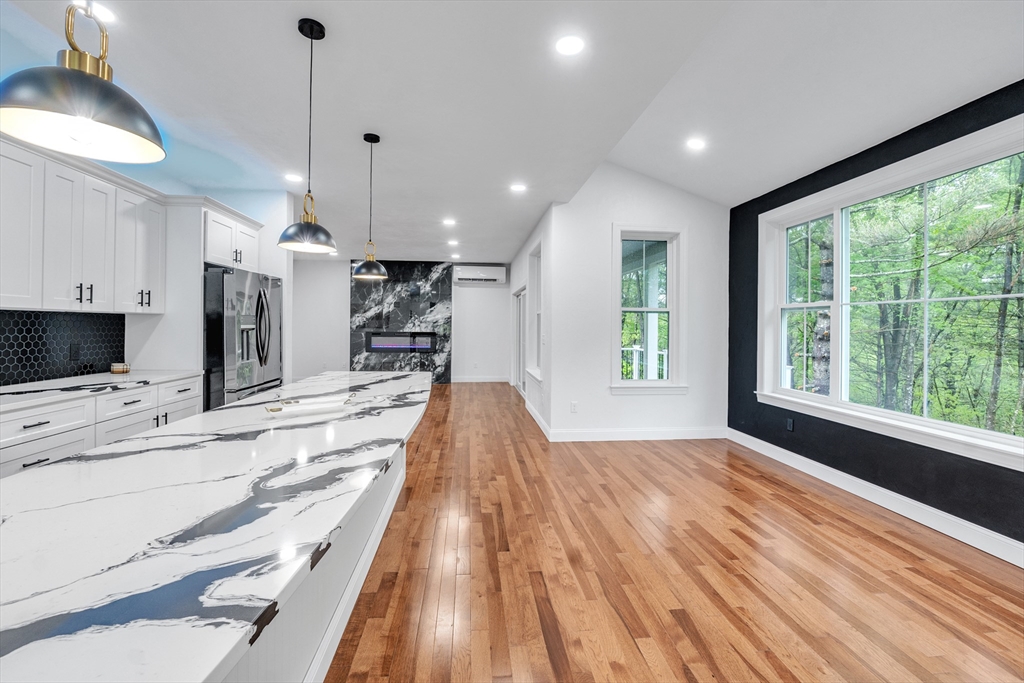 35 Blood Road Charlton, MA 01507 - Photo 18 of 38 a large kitchen with kitchen island granite countertop a large window and stainless steel appliances