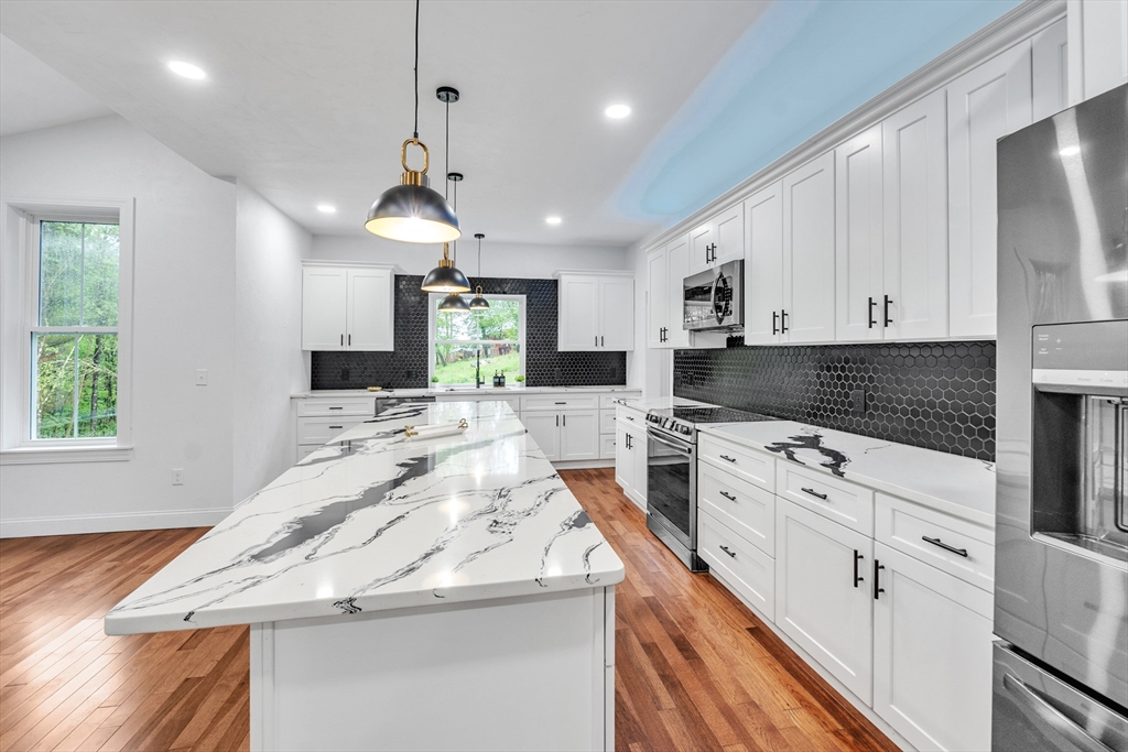 35 Blood Road Charlton, MA 01507 - Photo 20 of 38 a kitchen with stainless steel appliances kitchen island granite countertop a sink stove and cabinets