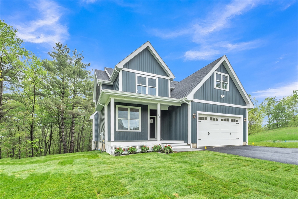 35 Blood Road Charlton, MA 01507 - Photo 2 of 38 a front view of a house with a yard and garage