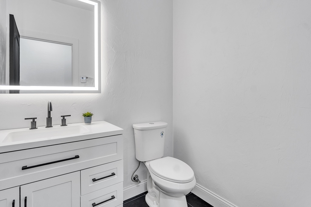 35 Blood Road Charlton, MA 01507 - Photo 10 of 38 a bathroom with a toilet a sink a vanity and mirror