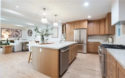a living room with furniture a dining table and kitchen view
